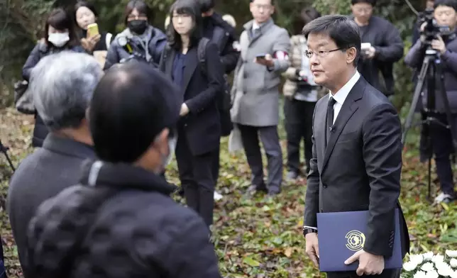 South Korean Ambassador to Japan Park Cheol-hee, right, delivers a speech to the relatives of Korean victims and South Korean officials during a memorial service at the site of former Fourth Souai Dormitory for the mine workers from the Korean Peninsula, in Sado, Niigata prefecture, Japan, Monday, Nov. 25, 2024. (AP Photo/Eugene Hoshiko)