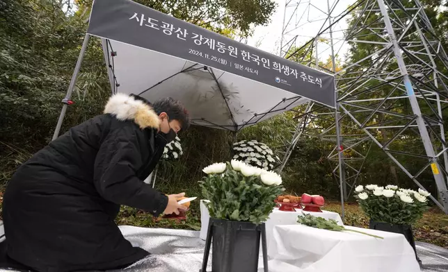 A staff prepare offerings prior to a memorial service held by relatives of Korean victims and South Korean officials in Sado, Niigata prefecture, Japan, Monday, Nov. 25, 2024, after boycotting a memorial organized by Japanese officials. (AP Photo/Eugene Hoshiko)