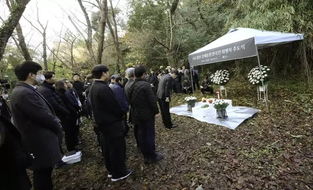 South Korean Ambassador to Japan Park Cheol-hee, right, bows to an altar as the relatives of Korean victims and South Korean officials during a memorial service at the site of former Fourth Souai Dormitory for the mine workers from the Korean Peninsula, in Sado, Niigata prefecture, Japan, Monday, Nov. 25, 2024. (AP Photo/Eugene Hoshiko)