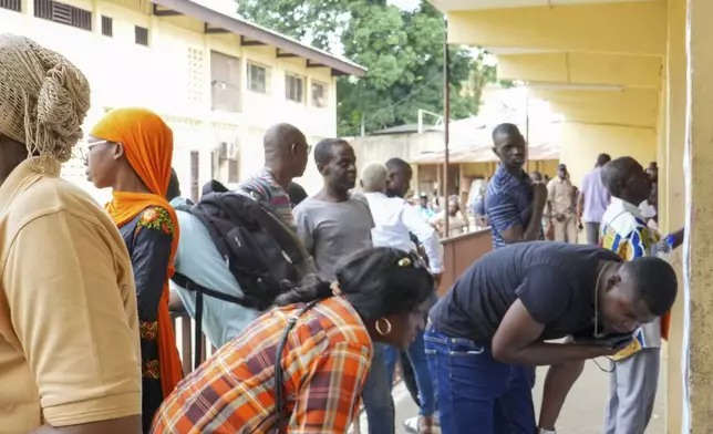 People line up to vote in a referendum on whether to adopt a new constitution, in Libreville, Gabon, Saturday, Nov. 16, 2024. (AP Photo/Betines Makosso)