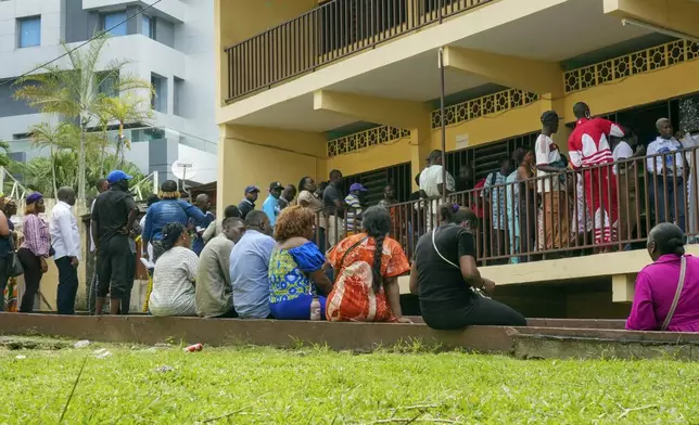 People line up to vote in a referendum on whether to adopt a new constitution, in Libreville, Gabon, Saturday, Nov. 16, 2024. (AP Photo/Betines Makosso)