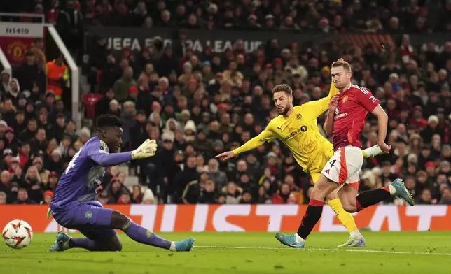 Bodo Glimt's Philip Zinckernagel, center, scores during the Europa League opening phase soccer match between Manchester United and Bodo Glimt, at the Old Trafford stadium in Manchester, England, Thursday, Nov. 28, 2024. (Martin Rickett/PA via AP)