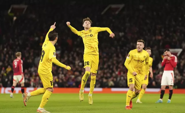 Bodo Glimt's Hakon Evjen, center, celebrates scoring during the Europa League opening phase soccer match between Manchester United and Bodo Glimt, at the Old Trafford stadium in Manchester, England, Thursday, Nov. 28, 2024. (Martin Rickett/PA via AP)