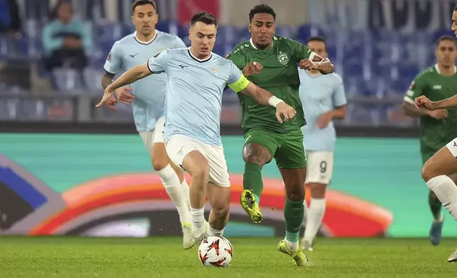 Lazio's Patric, left, and Ludogorets' Rwan Cruz fight for the ball during an Europa League soccer match between Lazio and Ludogorets, at Rome's Olympic Stadium, Thursday, Nov. 28, 2024. (AP Photo/Andrew Medichini)