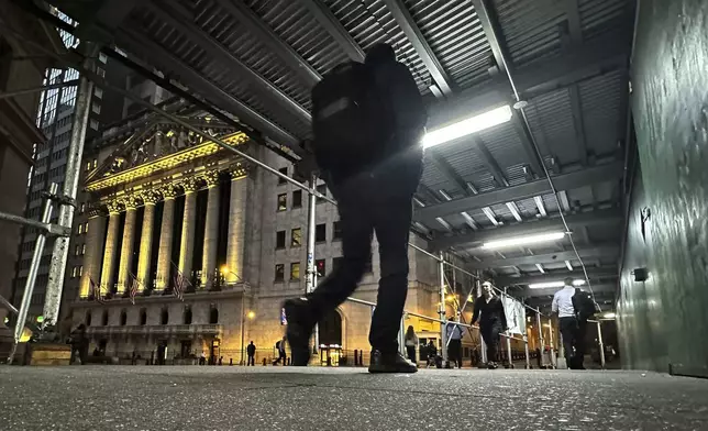 FILE - People walk under a sidewalk shed near the New York Stock Exchange on Oct. 30, 2024. (AP Photo/Peter Morgan, File)