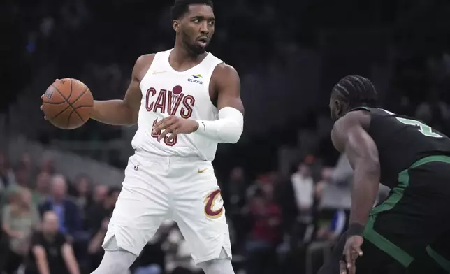 Cleveland Cavaliers guard Donovan Mitchell (45) sets to drive against Boston Celtics guard Jaylen Brown (7) during the first half of an Emirates NBA Cup basketball game, Tuesday, Nov. 19, 2024, in Boston. (AP Photo/Charles Krupa)