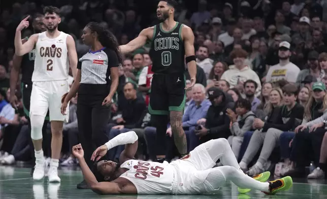 Cleveland Cavaliers guard Donovan Mitchell drops to the floor after colliding with Boston Celtics forward Jayson Tatum (0) during the second half of an Emirates NBA Cup basketball game, Tuesday, Nov. 19, 2024, in Boston. (AP Photo/Charles Krupa)