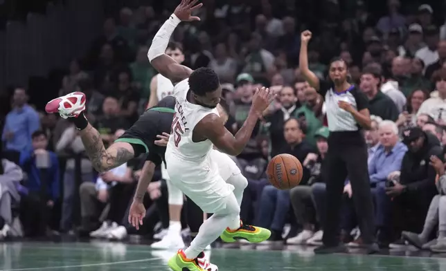 Boston Celtics forward Jayson Tatum, rear, collides with Cleveland Cavaliers guard Donovan Mitchell during the second half of an Emirates NBA Cup basketball game, Tuesday, Nov. 19, 2024, in Boston. (AP Photo/Charles Krupa)