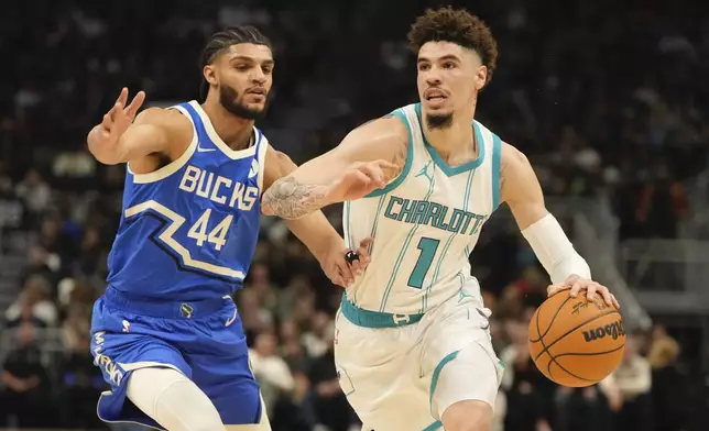 Charlotte Hornets' LaMelo Ball tries to get past Milwaukee Bucks' Andre Jackson Jr. during the first half of an NBA basketball game Saturday, Nov. 23, 2024, in Milwaukee. (AP Photo/Morry Gash)