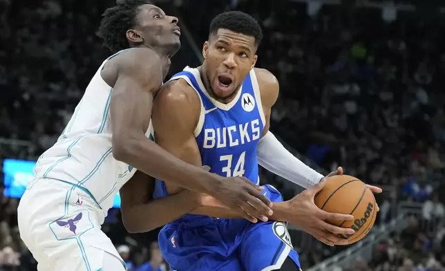 Charlotte Hornets' Moussa Diabate fouls Milwaukee Bucks' Giannis Antetokounmpo during the second half of an NBA basketball game Saturday, Nov. 23, 2024, in Milwaukee. The Bucks won 125-119. (AP Photo/Morry Gash)