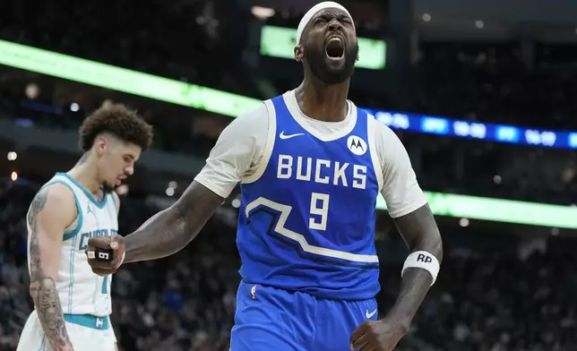 Milwaukee Bucks' Bobby Portis reacts in front of Charlotte Hornets' LaMelo Ball during the second half of an NBA basketball game Saturday, Nov. 23, 2024, in Milwaukee. The Bucks won 125-119. (AP Photo/Morry Gash)