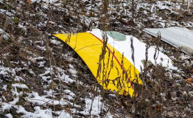 A piece of debris from a DHL cargo plane which crashed into a house is seen near the Lithuanian capital Vilnius, Lithuania, Monday, Nov. 25, 2024. (AP Photo/Mindaugas Kulbis)