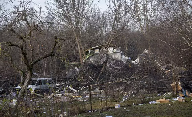 A view of the wreckage of the DHL cargo plane that crashed into a house near Vilnius, Lithuania, Monday, Nov. 25, 2024. (AP Photo/Mindaugas Kulbis)