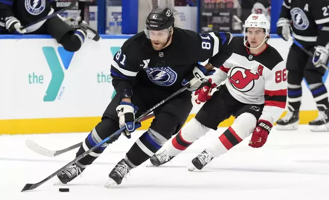 Tampa Bay Lightning defenseman Erik Cernak (81) works around New Jersey Devils center Jack Hughes (86) during the first period of an NHL hockey game Saturday, Nov. 16, 2024, in Tampa, Fla. (AP Photo/Chris O'Meara)