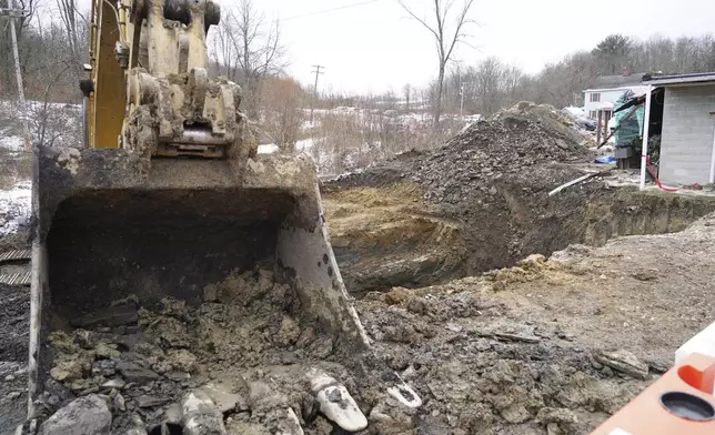 Crews work near the sinkhole where the remains of Elizabeth Pollard were found, Friday, Dec. 6, 2024 in Marguerite, Pa. (AP Photo/Matt Freed)
