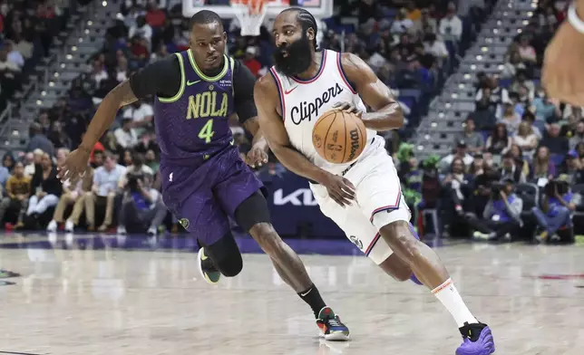 Los Angeles Clippers guard James Harden (1) tries to drive past New Orleans Pelicans guard Javonte Green (4) in the first half of an NBA basketball game in New Orleans, Monday, Dec. 30, 2024. (AP Photo/Peter Forest)