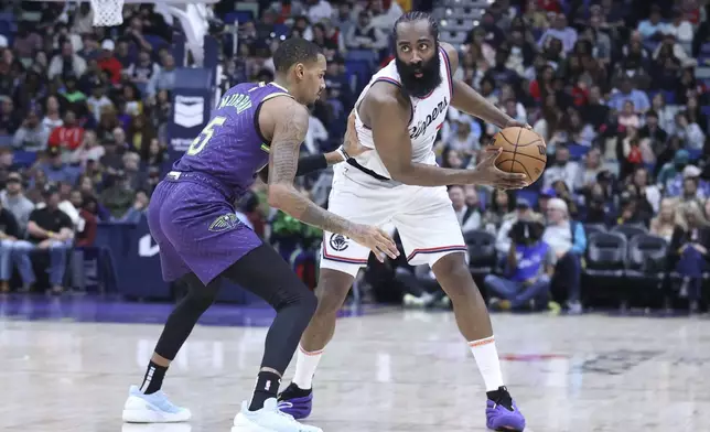 Los Angeles Clippers guard James Harden tries to make a move against New Orleans Pelicans guard Dejounte Murray (5) in the first half of an NBA basketball game in New Orleans, Monday, Dec. 30, 2024. (AP Photo/Peter Forest)