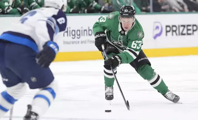 Dallas Stars right wing Evgenii Dadonov (63) moves the puck against Winnipeg Jets defenseman Colin Miller (6) during the first period of an NHL hockey game Sunday, Dec. 1, 2024, in Dallas. (AP Photo/LM Otero)