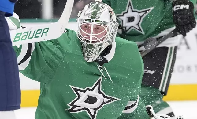 Dallas Stars goaltender Jake Oettinger (29) deflects a shot during the second period of an NHL hockey game against the Winnipeg Jets, Sunday, Dec. 1, 2024, in Dallas. (AP Photo/LM Otero)