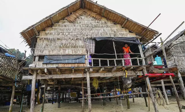 Kiroom Klathale stands on her house at Surin Islands in Phang Nga Province, Thailand, Thursday, Dec. 12, 2024. (AP Photo/Sakchai Lalit)