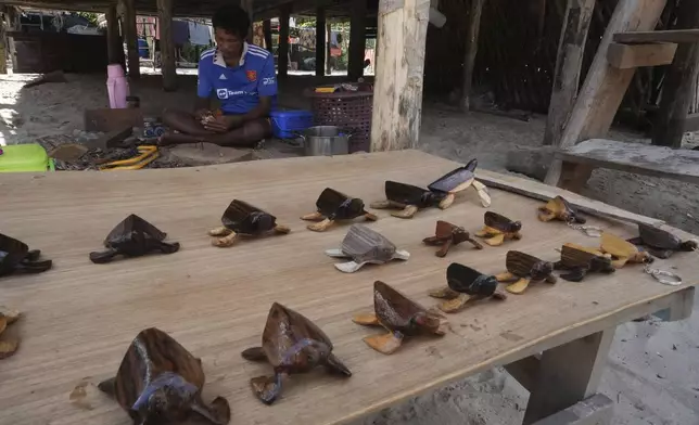 Pek Klathale makes handicraft for tourists to buy in Moken village at Surin Islands in Phang Nga Province, Thailand, Wednesday, Dec. 11, 2024. (AP Photo/Sakchai Lalit)