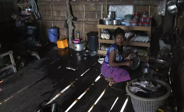 Bonbong Klathale cooks at her house in Moken village at Surin Island in Phang Nga Province, Thailand, Thursday, Dec. 12, 2024. (AP Photo/Sakchai Lalit)