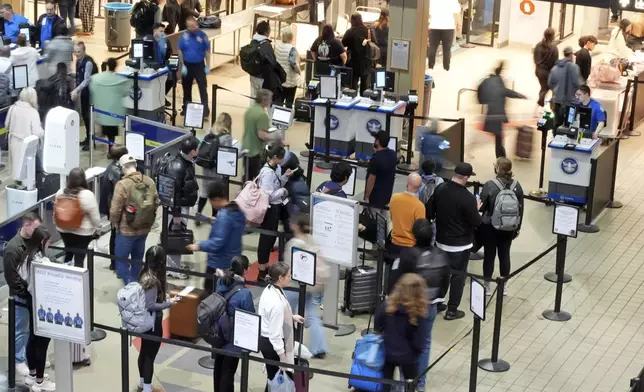 FILE - Passengers line up at the security checkpoint in Pittsburgh International Airport Dec. 11, 2024. (AP Photo/Gene J. Puskar, File)