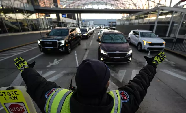 Traffic is stopped as people enter the Hartsfield-Jackson Atlanta International Airport, Friday, Dec. 20, 2024, in Atlanta. (AP Photo/Mike Stewart)