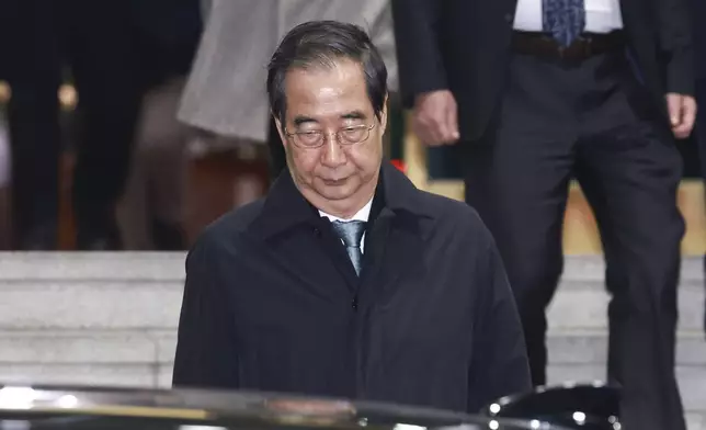 Impeached South Korean acting President Han Duck-soo leaves the government complex building in Seoul, South Korea, Friday, Dec. 27, 2024. (Hong Hae-in/Yonhap via AP)