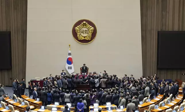 Lawmakers of the ruling People Power Party protest to South Korea's National Assembly Speaker Woo Won Shik, top center, during a plenary session for the impeachment motion against South Korean acting President Han Duck-soo at the National Assembly in Seoul, South Korea, Friday Dec. 27, 2024. (AP Photo/Ahn Young-joon)