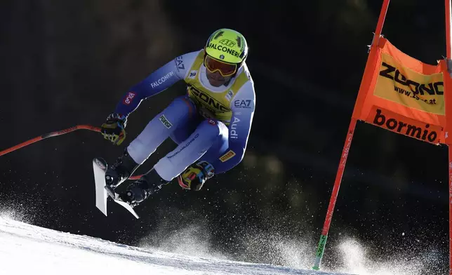 Italy's Christof Innerhofer speeds down the course during an alpine ski, men's World Cup downhill race, in Bormio, Italy, Saturday, Dec. 28, 2024. (AP Photo/Gabriele Facciotti)