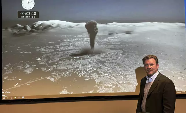 Brooke Buddemeier, a radiation safety specialist at Lawrence Livermore National Laboratory, stands in front of a screen showing the impact of nuclear detonation, in Livermore, Calif., Thursday, Aug. 22, 2024. (AP Photo/Terry Chea)