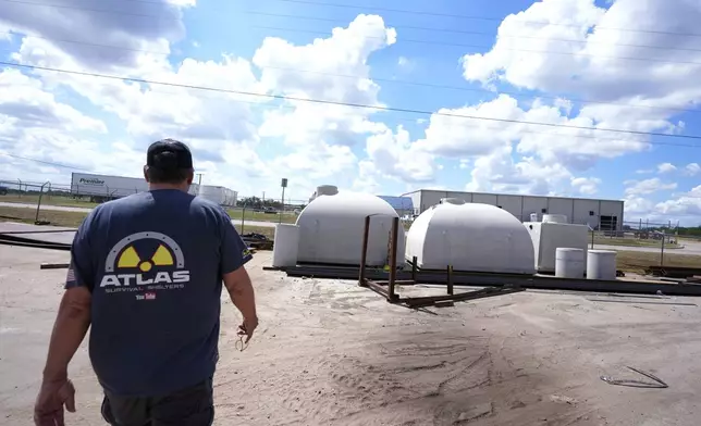 Ron Hubbard, owner of Atlas Survival Shelters, walks over to concrete bunkers during a tour of his operations in Sulphur Springs, Texas, on Aug. 27, 2024, (AP Photo/LM Otero)