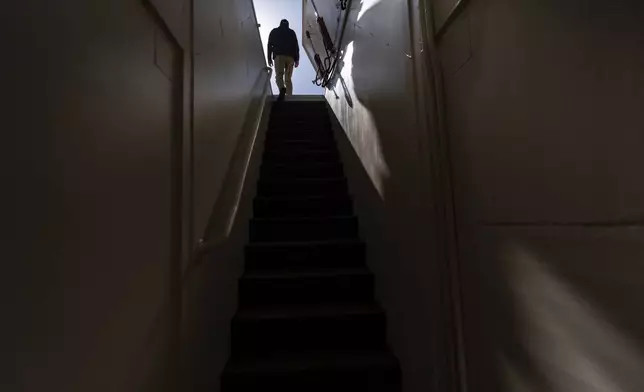 The owner, who asked not to be identified because of concerns about his privacy, walks up the steps of his underground shelter in an undisclosed Southern California city, on Dec. 16, 2024. (AP Photo/Jae C. Hong)