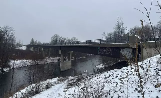 Rain and snow falls near the Presumpscot River in Falmouth, Maine as officials are watching for flooding on New England rivers, Wednesday, Dec. 11, 2024. (AP Photo/Patrick Whittle)