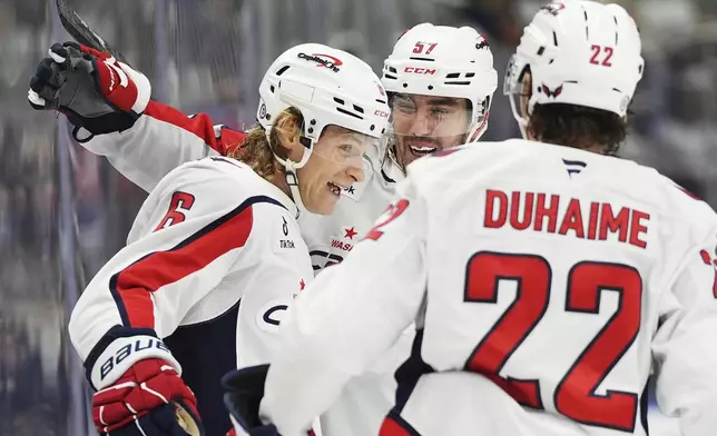 Washington Capitals' Jakob Chychrun (6) celebrates after his goal against the Toronto Maple Leafs with Trevor van Riemsdyk (57) and Brandon Duhaime (22) during first-period NHL hockey game action in Toronto, Saturday, Dec. 28, 2024. (Frank Gunn/The Canadian Press via AP)