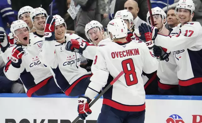 Washington Capitals' Alex Ovechkin (8) celebrates after his empty-net goal against the Toronto Maple Leafs during third-period NHL hockey game action in Toronto, Saturday, Dec. 28, 2024. (Frank Gunn/The Canadian Press via AP)