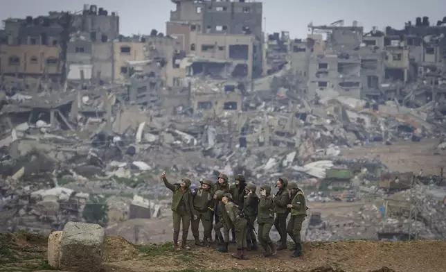 Female Israeli soldiers pose for a photo in southern Israel, on the border of the Gaza Strip, on Feb. 19, 2024. (AP Photo/Tsafrir Abayov)