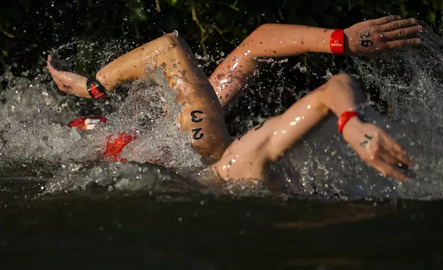 Athletes compete during the men's 10km marathon swimming competition at the 2024 Summer Olympics in Paris, France, on Aug. 9, 2024. (AP Photo/Vadim Ghirda)