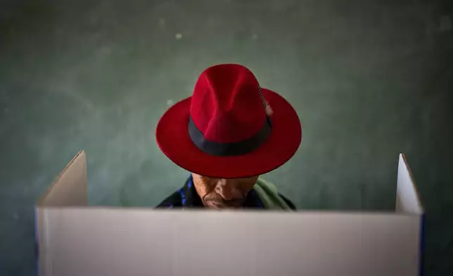 A voter fills out a ballot during general elections in Nkandla, Kwazulu Natal, South Africa, on May 29, 2024. (AP Photo/Emilio Morenatti)