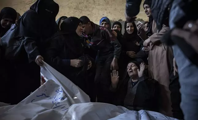 Members of the Abu Sinjar family mourn their relatives killed in an Israeli bombardment of the Gaza Strip, at their house in Rafah, southern Gaza, on Jan. 5, 2024. (AP Photo/Fatima Shbair)