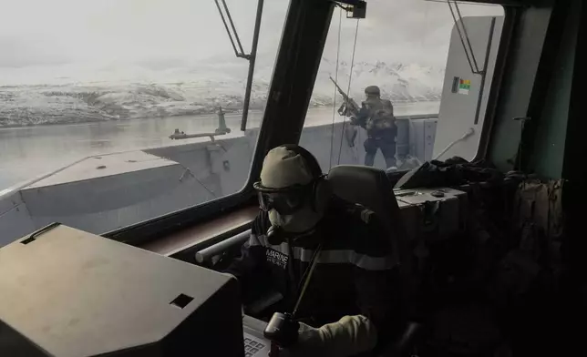 French sailors on the bridge of the French navy frigate Normandie keep watch during a reconnaissance patrol during NATO exercises in a Norwegian fjord north of the Arctic circle on March 6, 2024. (AP Photo/Thibault Camus)