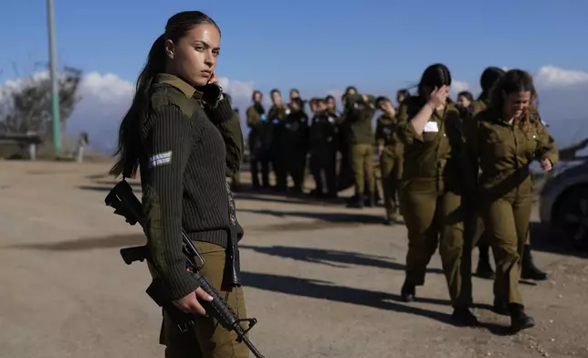 An Israeli soldier gives instruction to a platoon in northern Israel near the border with Lebanon, Thursday, Dec. 5, 2024. (AP Photo/Matias Delacroix)