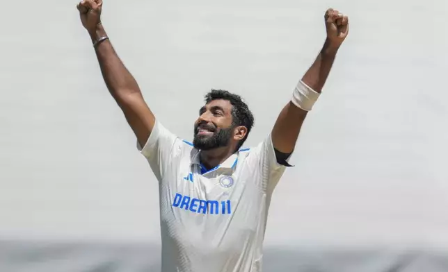 India's Jasprit Bumrah celebrates the wicket of Australia's Travis Head during play on the day four of the fourth cricket test between Australia and India at the Melbourne Cricket Ground, Melbourne, Australia, Sunday, Dec. 29, 2024. (AP Photo/Asanka Brendon Ratnayake)