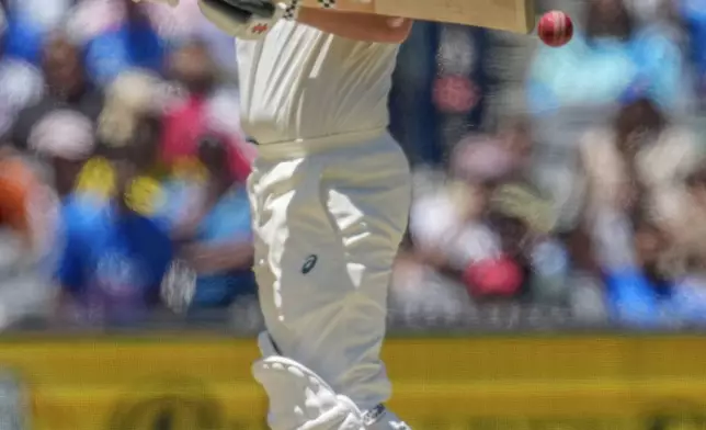 Australia's Travis Head plays a shot during play on the day four of the fourth cricket test between Australia and India at the Melbourne Cricket Ground, Melbourne, Australia, Sunday, Dec. 29, 2024. (AP Photo/Asanka Brendon Ratnayake)