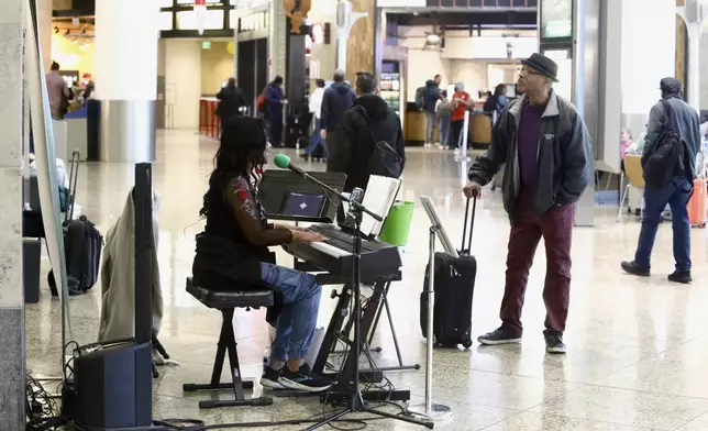 Roz McCommon performs at Seattle-Tacoma International Airport on November 26, 2024, in SeaTac, Wash. (AP Photo/Manuel Valdes)