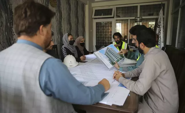 Engineers talk about the design of a luxury house at their office in the city of Kabul, Afghanistan, Sept. 23, 2024. (AP Photo/Siddiqullah Alizai)