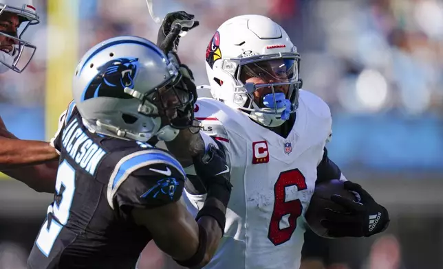 Arizona Cardinals running back James Conner runs past Carolina Panthers cornerback Michael Jackson during the first half of an NFL football game, Sunday, Dec. 22, 2024, in Charlotte, N.C. (AP Photo/Rusty Jones)