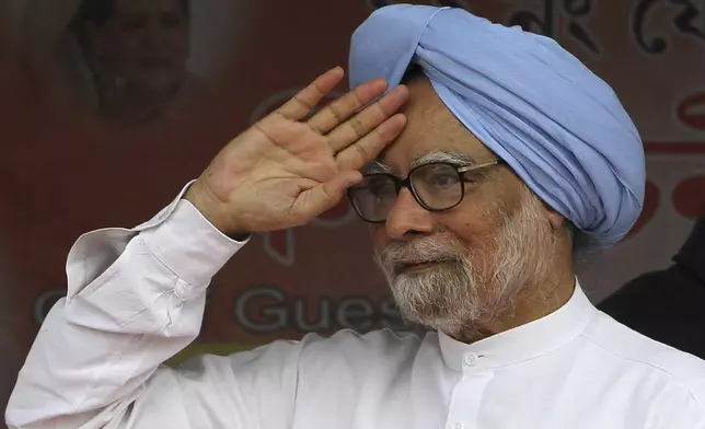 FILE - Indian Prime Minister Manmohan Singh greets the crowd during an election campaign rally at Khumtai, in the northeastern Indian state of Assam, Saturday, March 29, 2014. (AP Photo/Anupam Nath, File)