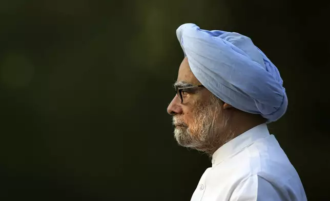 FILE - In this Wednesday, May 21, 2014 file photo, outgoing Indian prime minister Manmohan Singh leaves after paying homage to former Indian prime minister Rajiv Gandhi on his death anniversary, in New Delhi, India. (AP Photo/Manish Swarup, File)